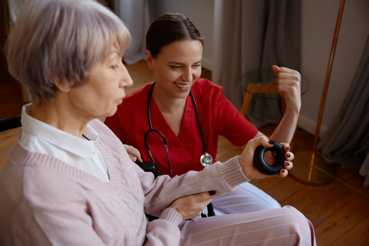 Senior woman in wheelchair working with her occupational therapist